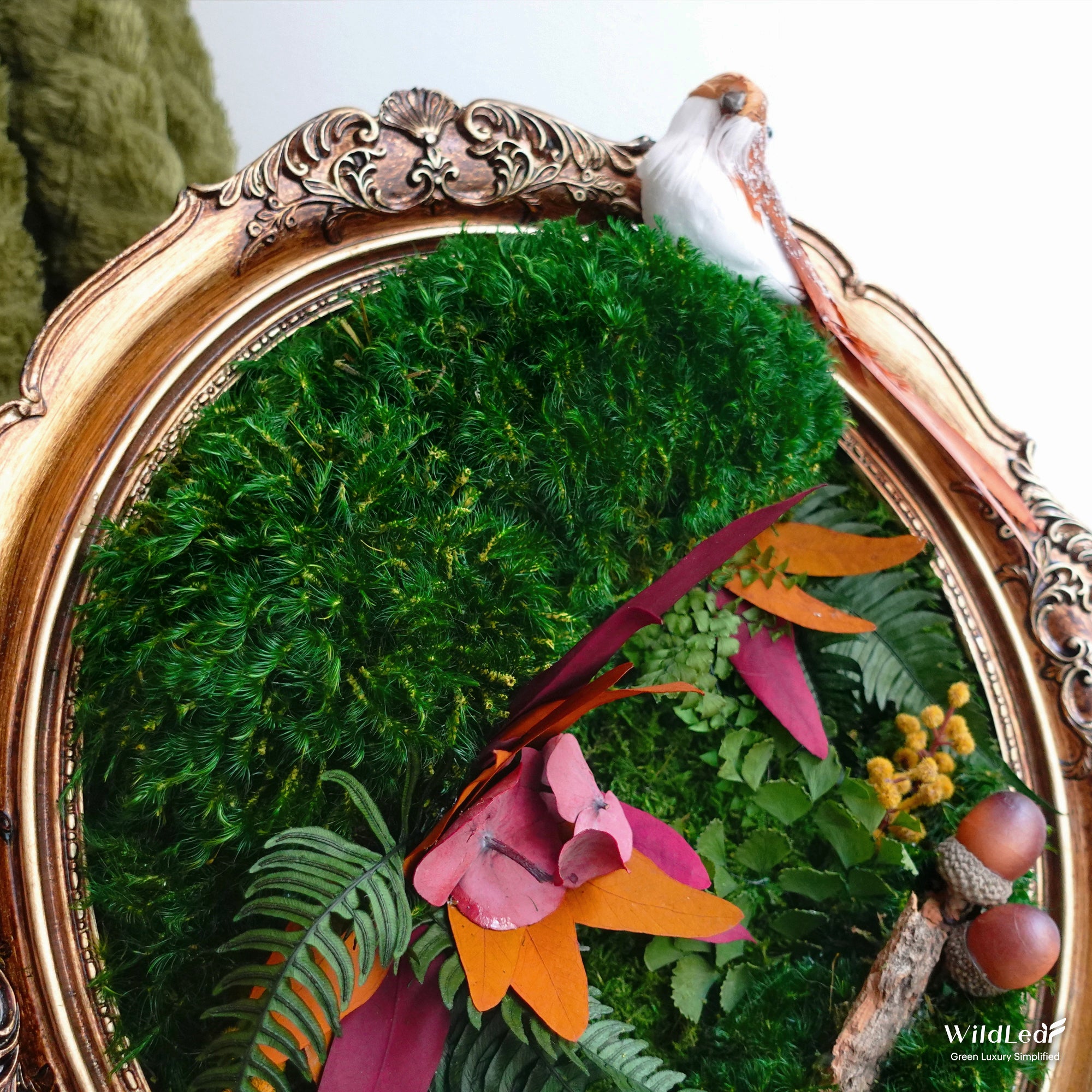 Close-up of ornate vintage frame and natural materials in the Vintage Oval Framed Fall Moss Wall Art, emphasizing craftsmanship.