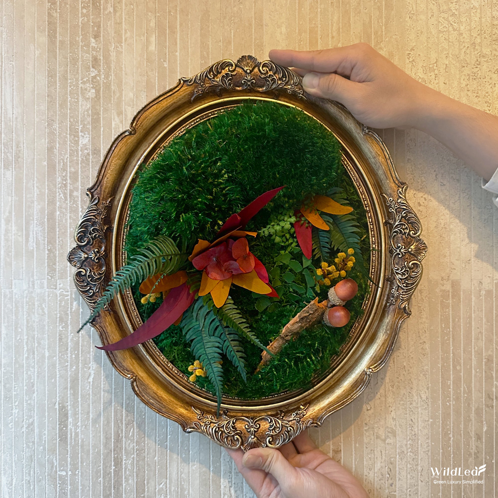 Vintage Oval Framed Fall Moss Wall Art displayed on a modern interior brick wall, perfect for holiday season.