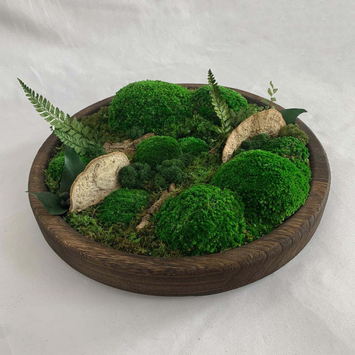 Round Wooden Moss Bowl with preserved moss and decorative plants, showcasing natural textures in a minimalist design
