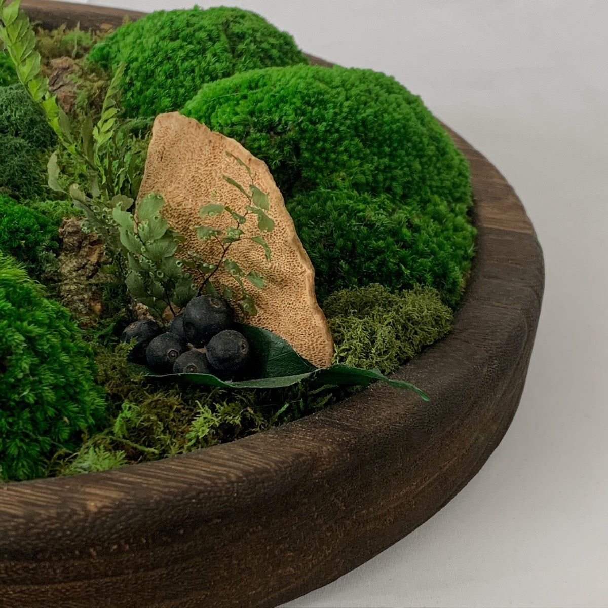 Round Wooden Moss Bowl with lush preserved moss and vibrant plants, showcasing natural textures and earthy elegance