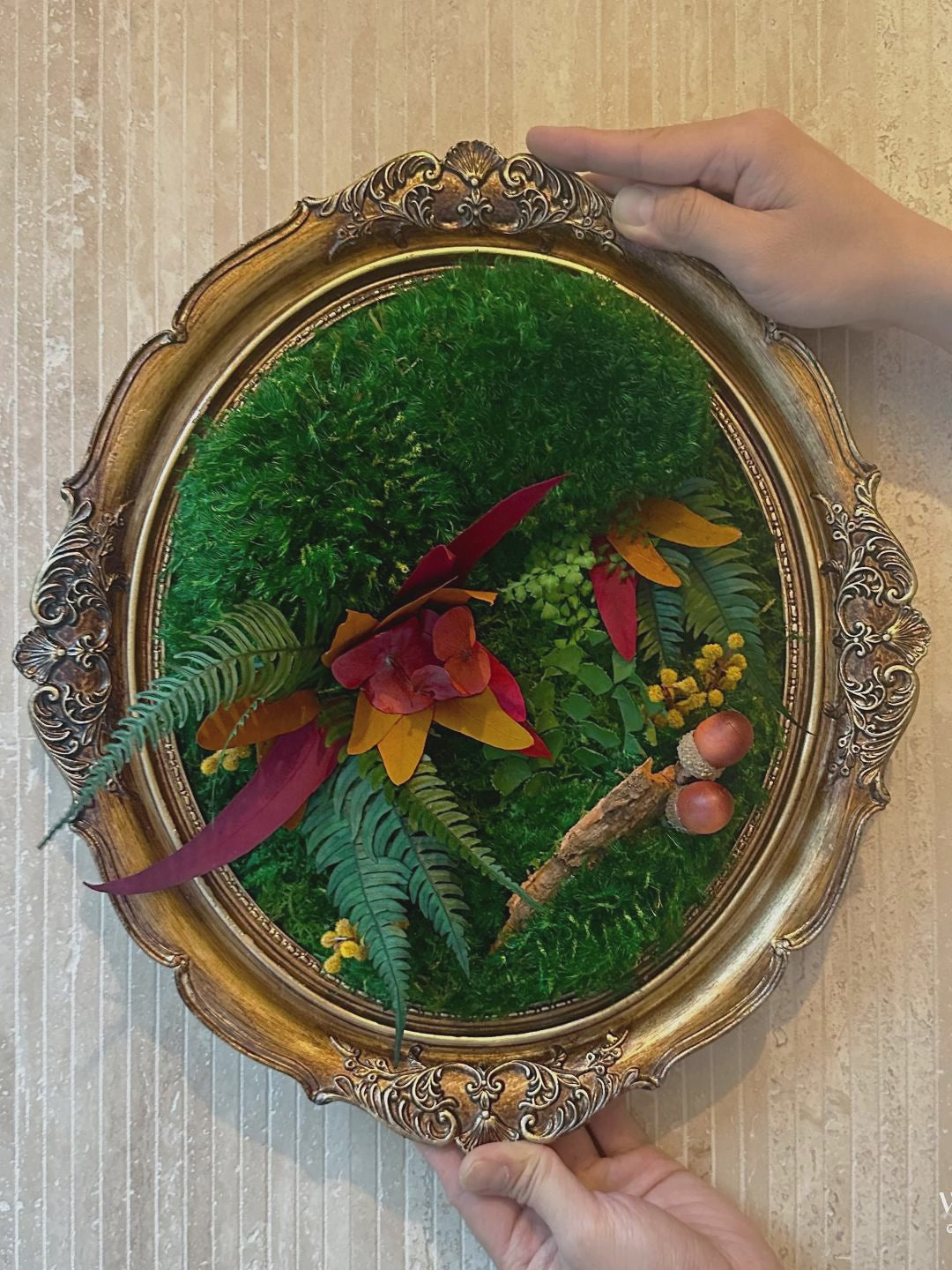 Encased in an ornate golden frame, this Autumn Inspired Moss Wall Art celebrates the vibrant colors and textures of fall.