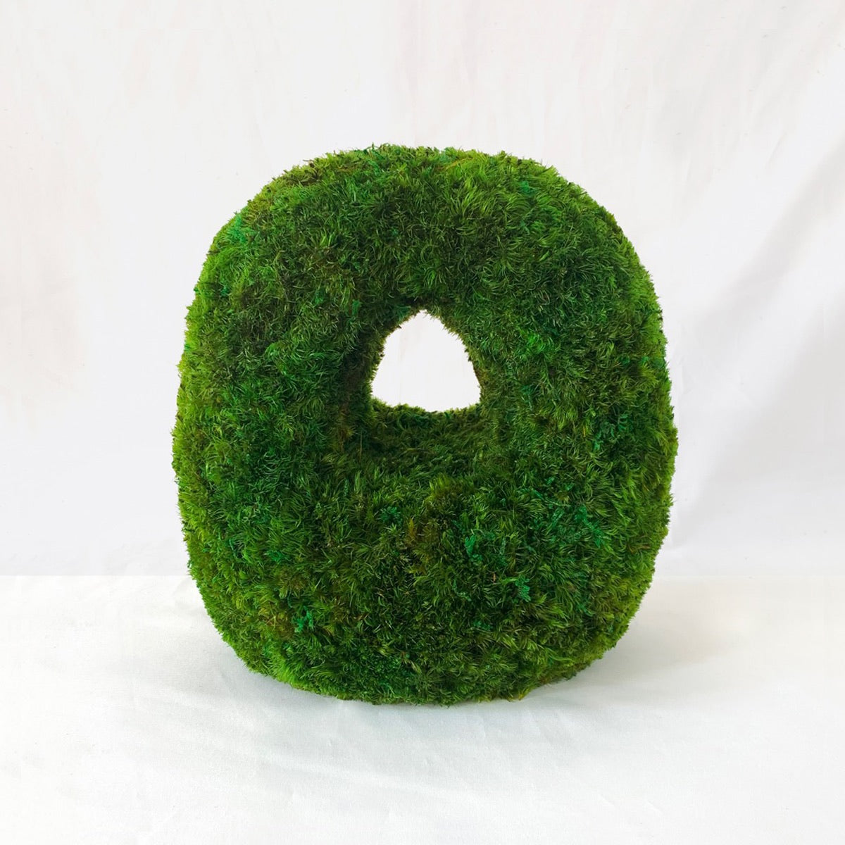 Arched Alcove sculptural moss tabletop featuring preserved green moss with a soft rounded arch opening, photographed on a white background