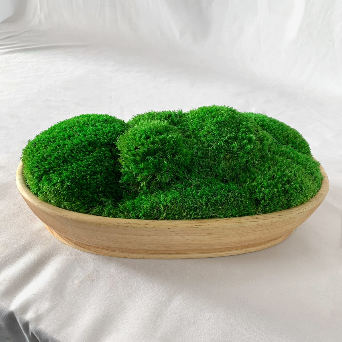 Boat shape wood moss bowl featuring preserved green moss, minimalist tabletop decor made from natural wood.