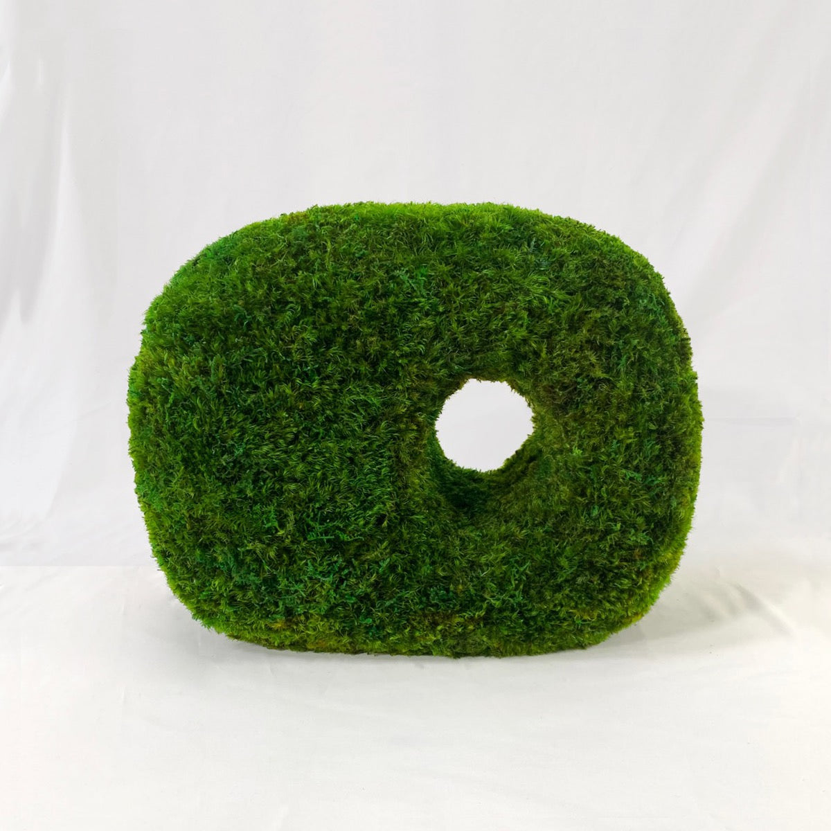 Guardian Cube sculptural moss tabletop featuring a rounded geometric form with a central opening, crafted from preserved green moss