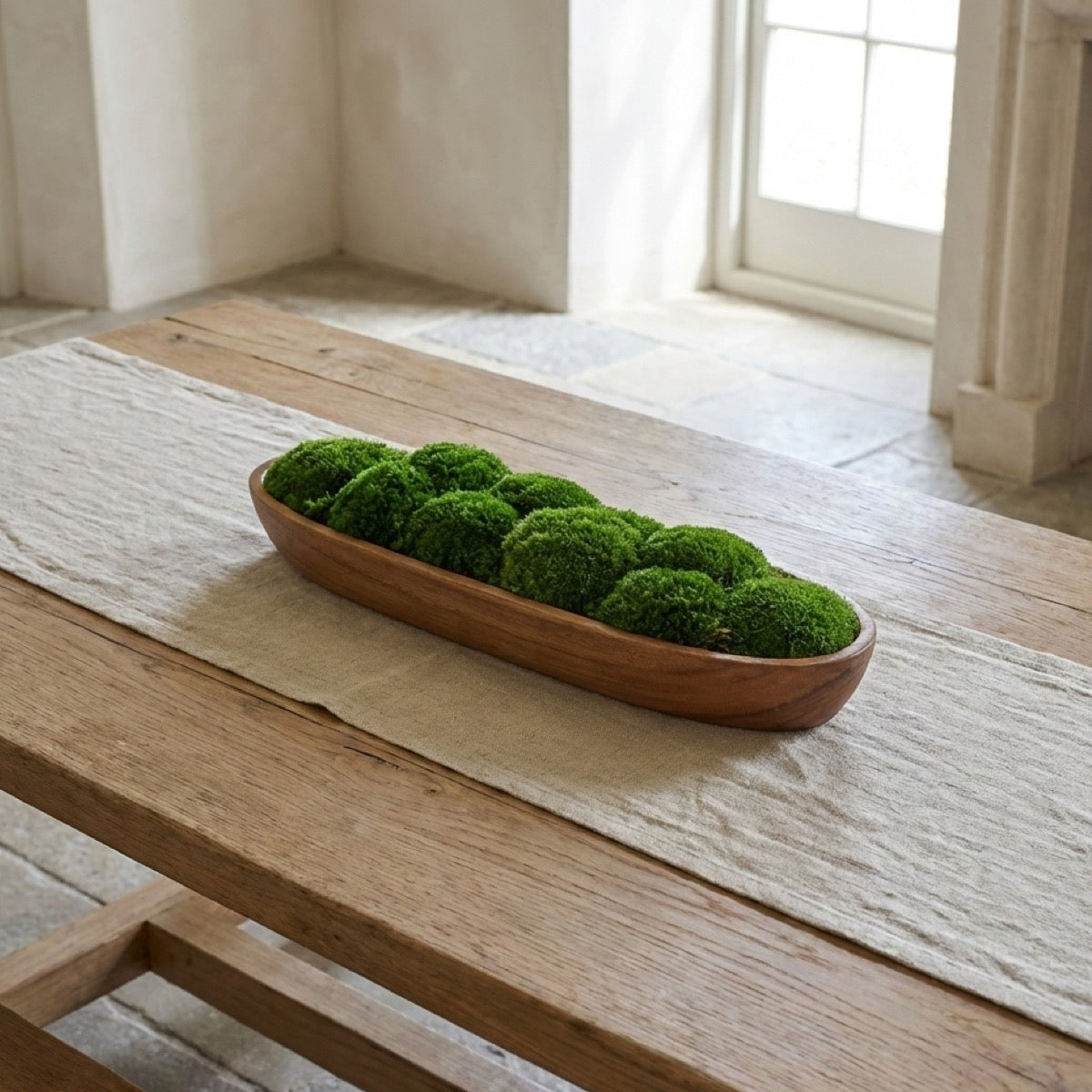 Long walnut decorative moss bowl filled with preserved bun moss, styled on a rustic wooden table in soft natural light.