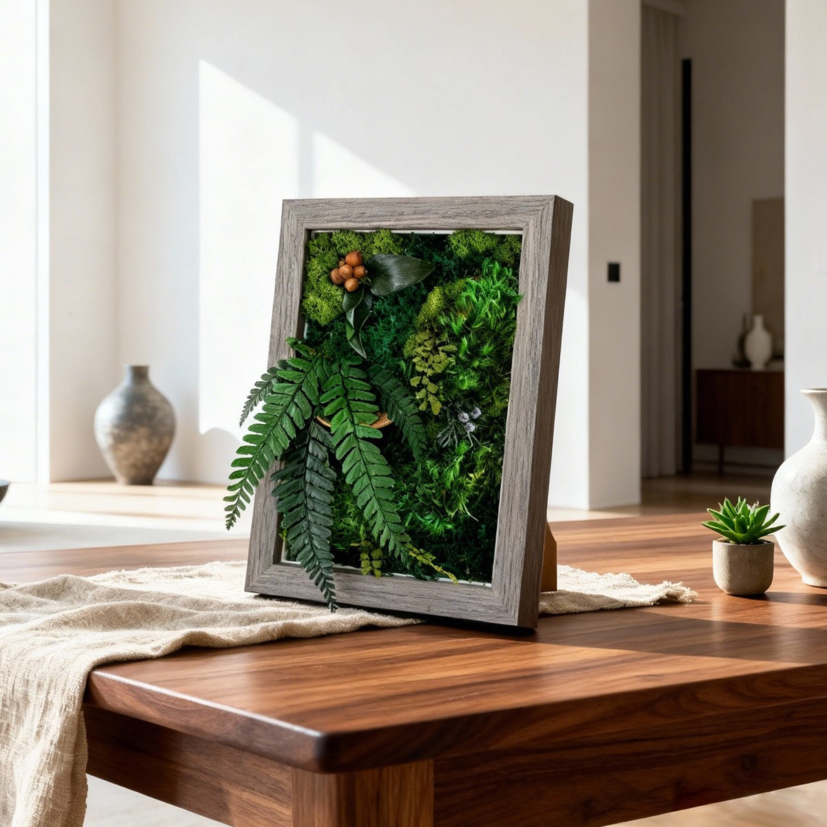 Walnut Lush Moss Table Frame standing on a wooden table in a bright modern living space.