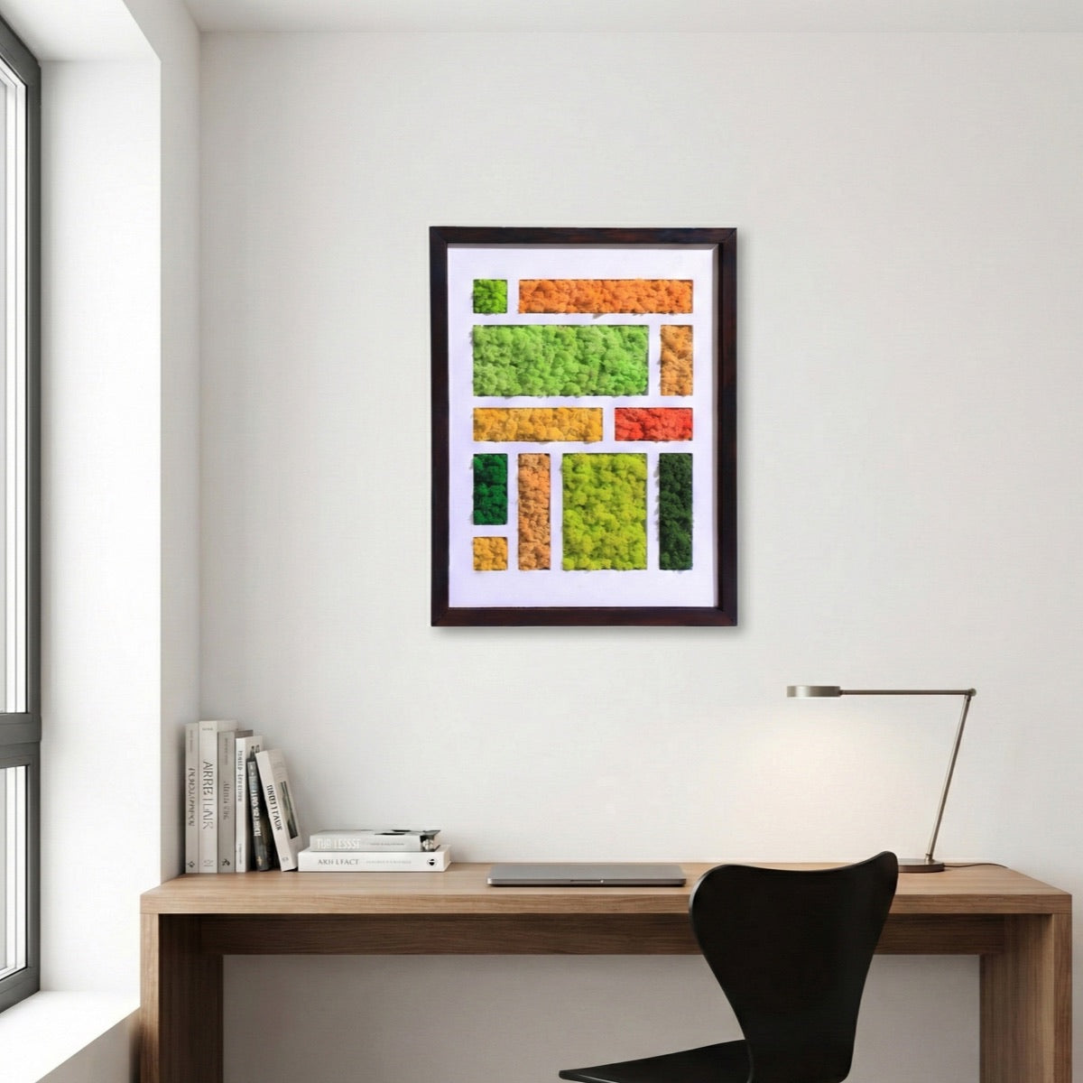 Mondrian-inspired reindeer moss art featuring geometric blocks of preserved moss in green and warm tones, framed and displayed in a modern home office setting.