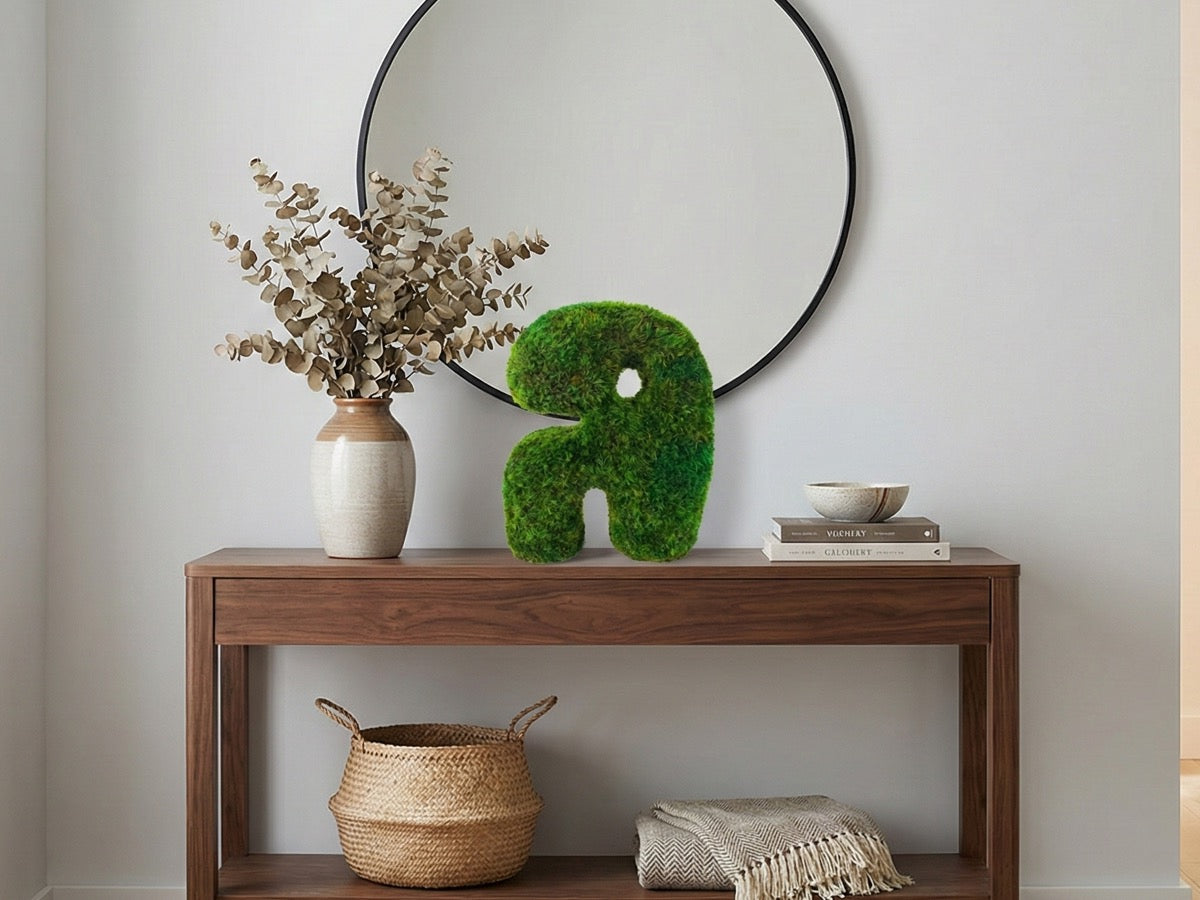 Preserved moss tabletop sculpture styled on a wooden console table, adding natural texture to a modern minimalist interior.