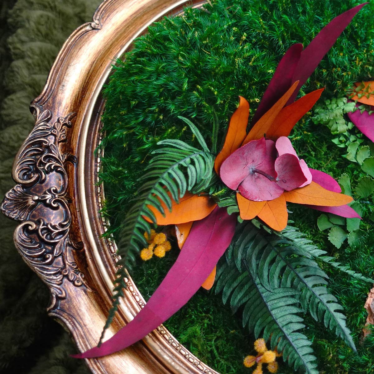 Close-up of vintage oval moss wall art showing preserved moss texture, autumn leaves, botanical details, and ornate antique-style frame.