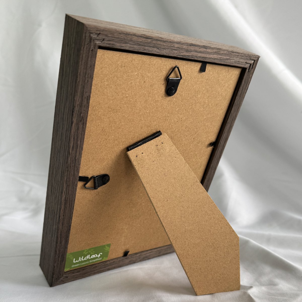 Back view of Lush Moss Table Frame in walnut showing vertical hanger, horizontal hanger, and foldable tabletop stand.